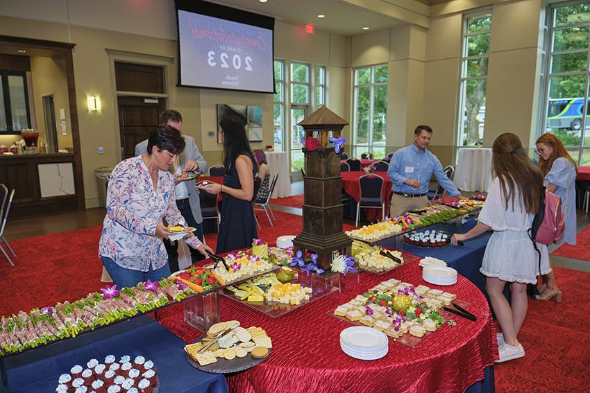 Attendees grabbing refreshments at the Champagne Toast