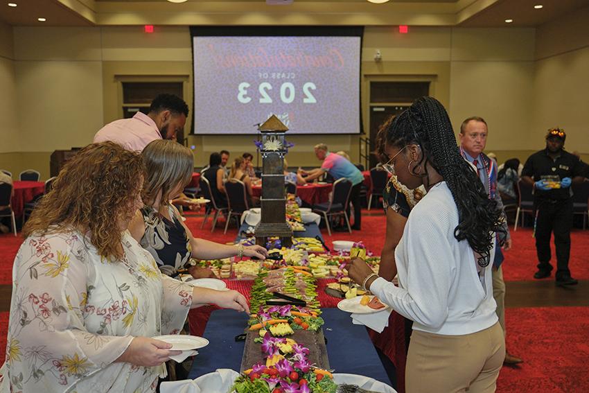 Attendees grabbing refreshments at the Champagne Toast