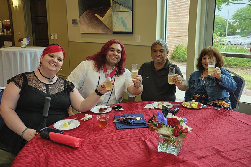 Attendees grabbing refreshments at the Champagne Toast