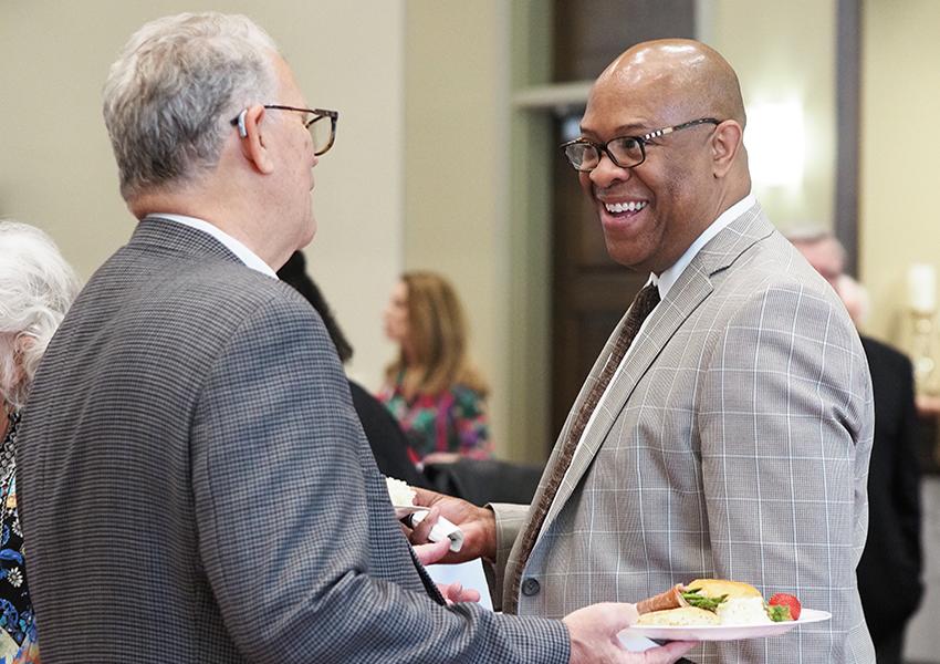 Dr. Mike Mitchell smiling speaking to alumni.