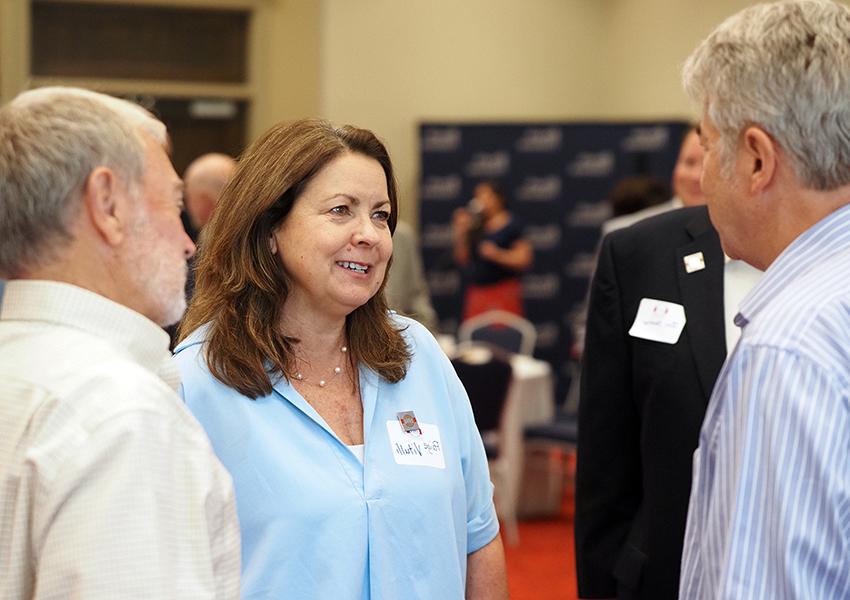 Dr. Paige Vitulli talking at a alumni event.