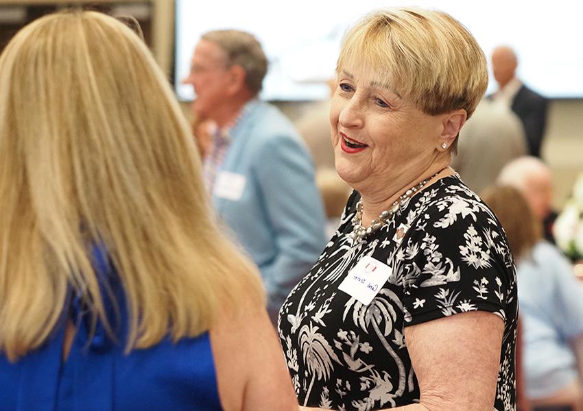 Woman smiling speaking with Karen Edwards.