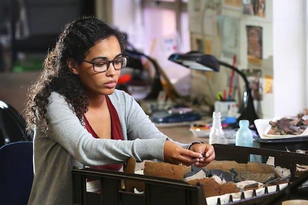 Female student working in lab on fossils.